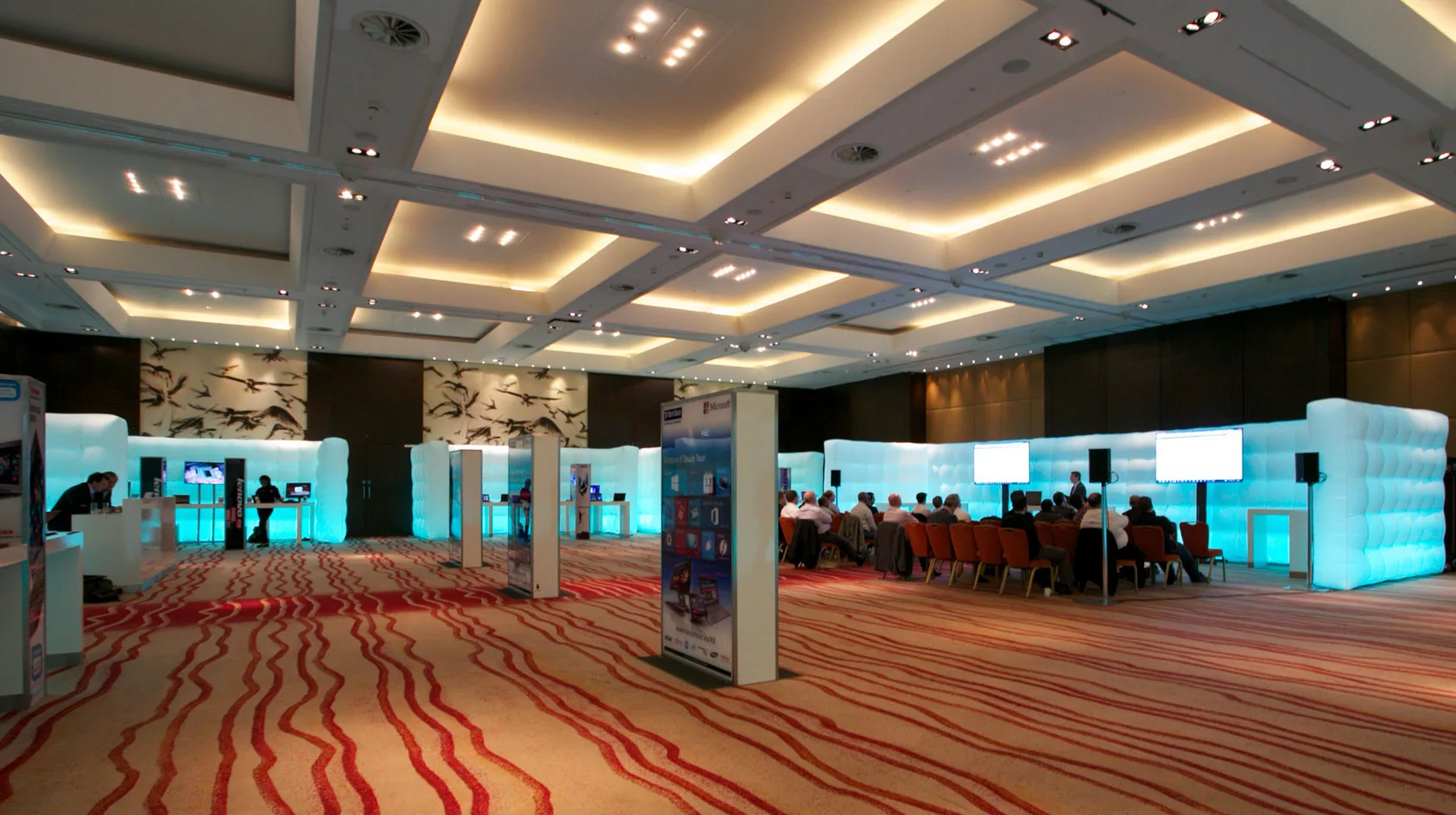 Pic showing several Created By Air Cubewalls used to divide up a presentation area at a large indoor event