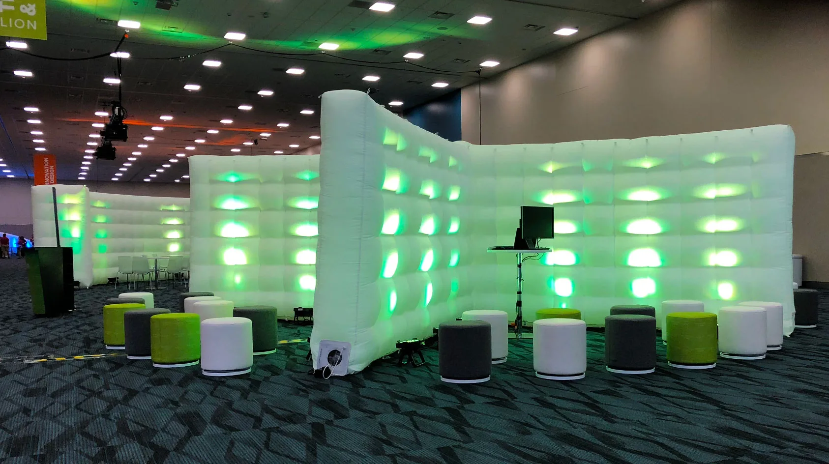 Pic showing a Created By Air Cross wall with green spot lighting installed at an indoor event
