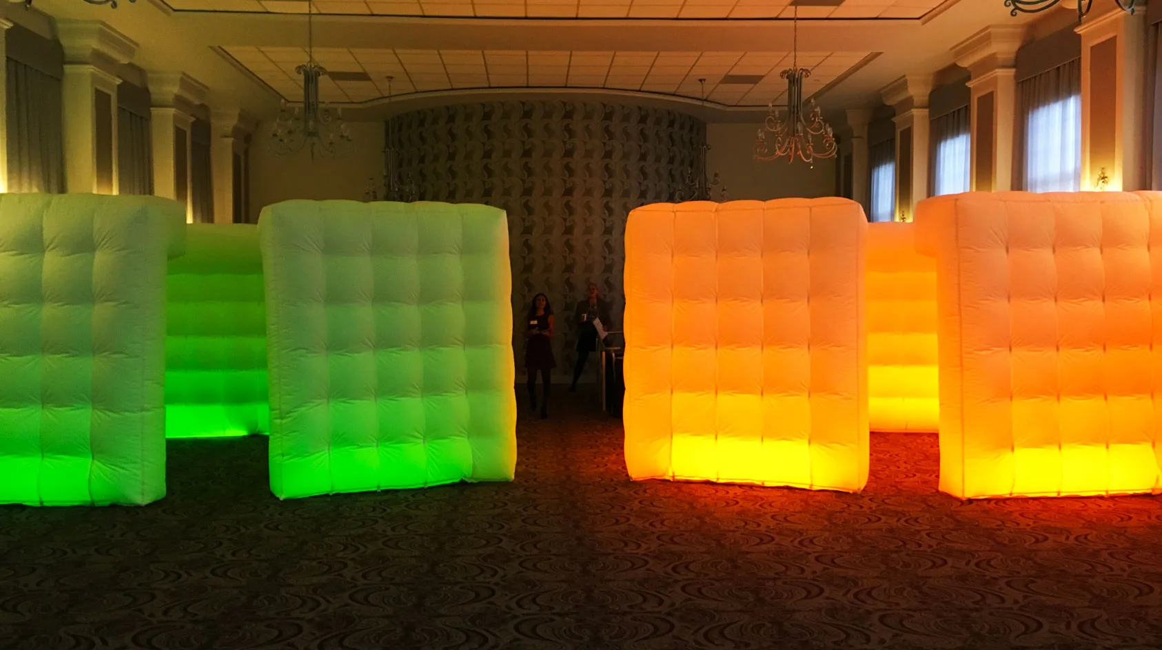 Pic showing a pair of Created By Air Boxer modular inflatable structures setup at the entrance to an indoor event