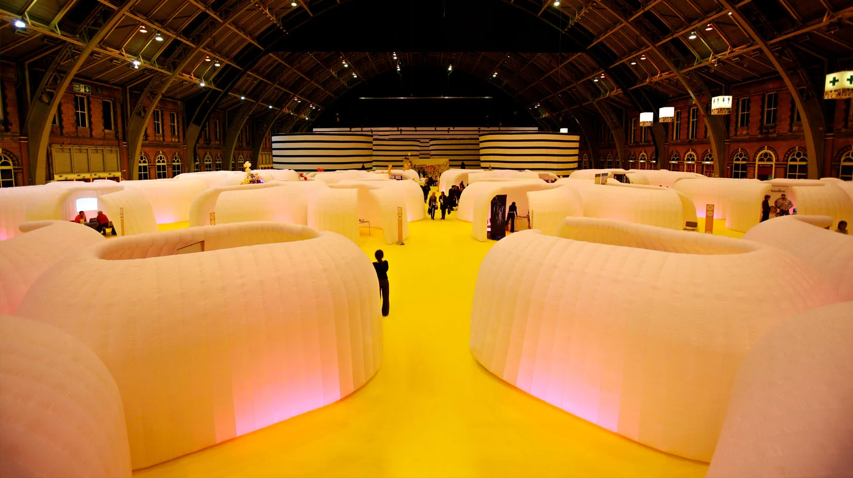 Pic showing lots of Created By Air inflatable office pods setup at a large indoor event