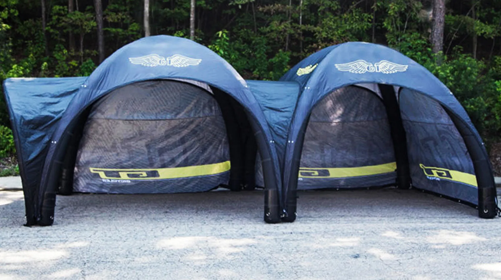 Pic showing two Created By Air X tent custom branded structures connected together using canopies