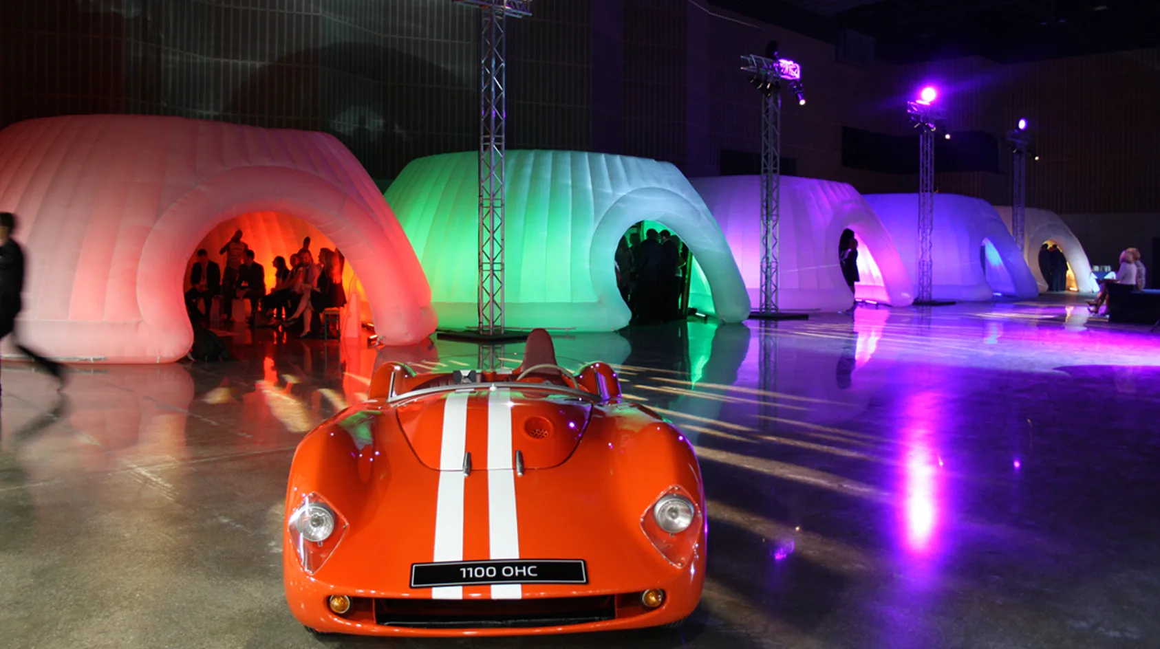 Pic showing several Created By Air Panoramic inflatable structures lit in different colours and used as breakout rooms